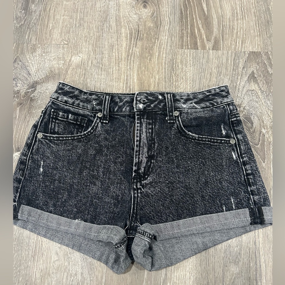 Slightly distressed looking black/grey jean shorts.